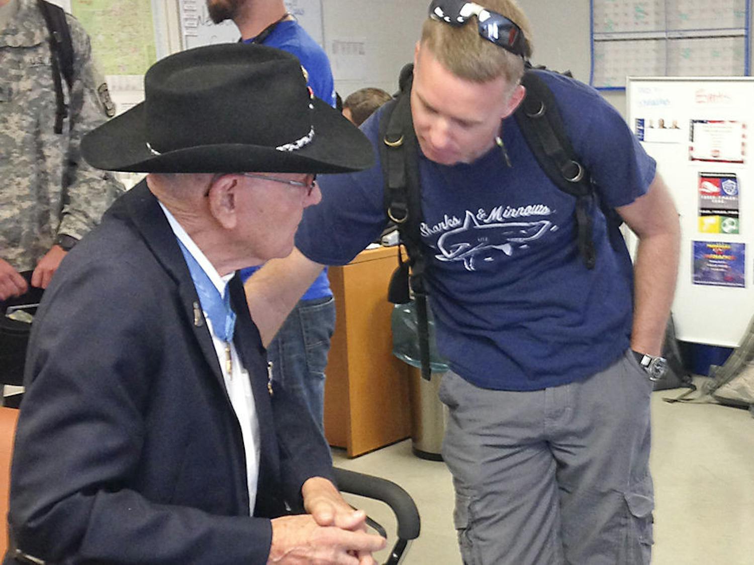 Retired Marine and Medal of Honor recipient Cpl. Duane Dewey speaks with 38-year-old UF materials science sophomore and Marine veteran Nate Adler at the Collegiate Veterans Success Center in Ben Hill Griffin Stadium on Thursday morning. Dewey came to speak to student veterans about his experiences in the Korean War and receiving his Medal of Honor.