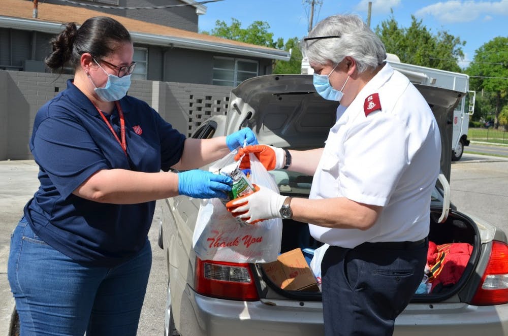 Priscilla Gonzalez helps to distribute supplies during The Salvation Army's food drive event Wednesday.