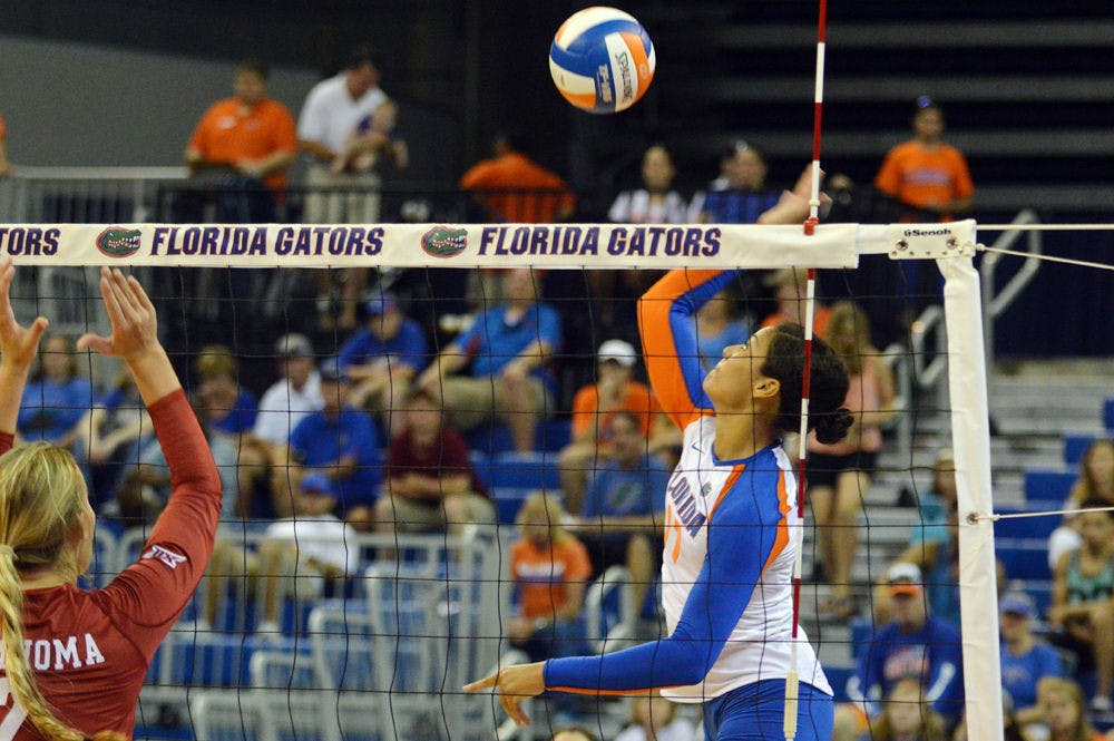 Noami Santos-Lamb swings for a kill attempt during Florida's 3-2 win against Oklahoma on Aug. 30, 2014, in the O'Connell Center.