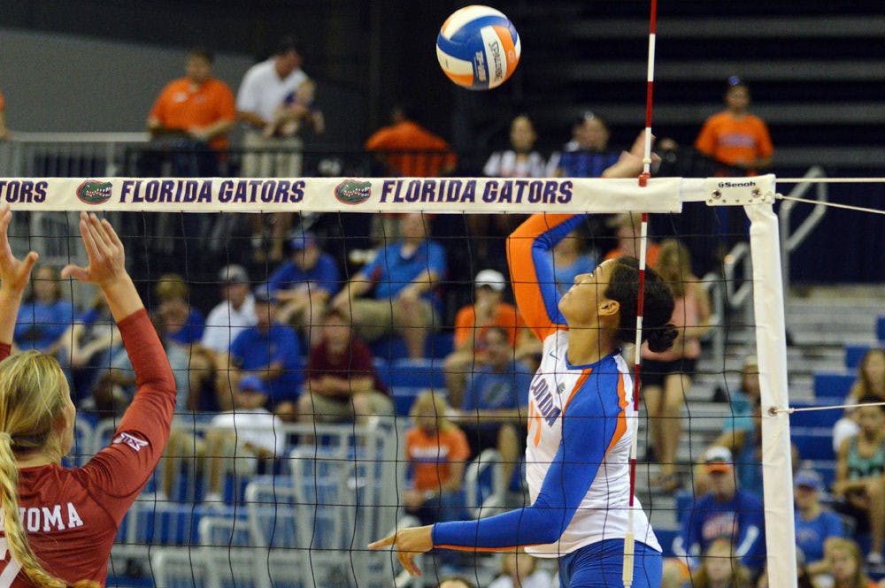 <p>Noami Santos-Lamb swings for a kill attempt during Florida's 3-2 win against Oklahoma on Aug. 30, 2014, in the O'Connell Center.</p>