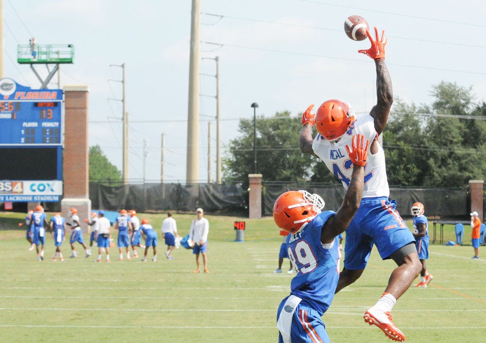 <p>UF defensive back Keanu Neal leaps to make a one-handed interception during practice Aug. 8, 2015, at Donald R. Dizney Stadium.</p>