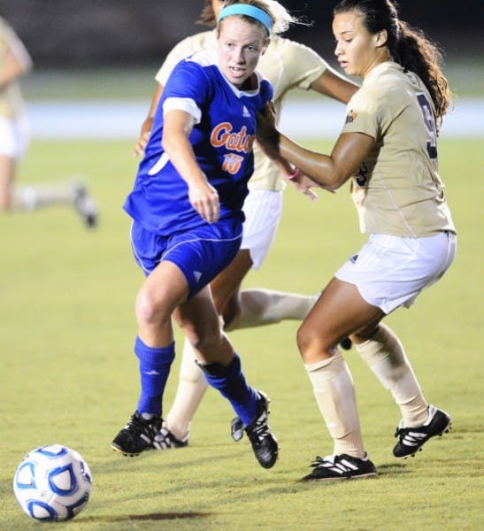 Tessa Andujar (15) moves the ball past Ashleigh Shim (9) during Sundays win against Florida International University at James G. Pressly Stadium.
&nbsp;
