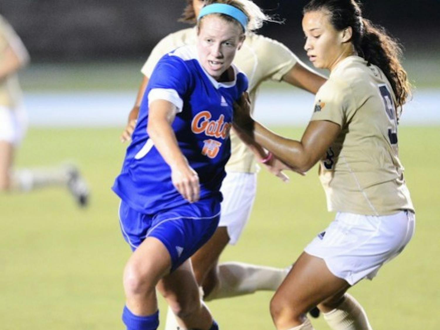 Tessa Andujar (15) moves the ball past Ashleigh Shim (9) during Sundays win against Florida International University at James G. Pressly Stadium.
 