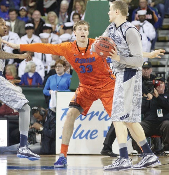 Florida forward Erik Murphy (33) guards Georgetown forward Nate Lubick during the Navy-Marine Corps Classic on Friday aboard the USS Bataan in Jacksonville.
