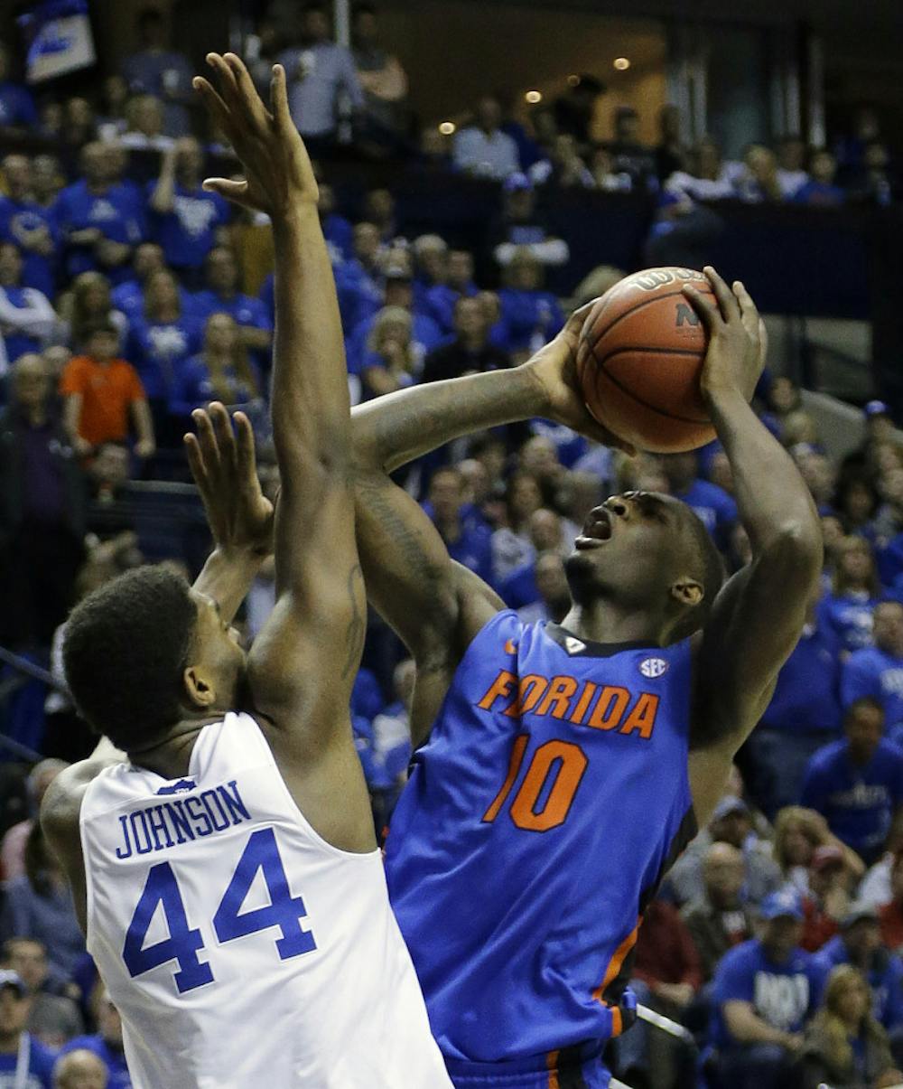<p>Florida forward Dorian Finney-Smith (10) shoots against Kentucky center Dakari Johnson (44) during the second half of an NCAA college basketball game in the quarter final round of the Southeastern Conference tournament, Friday, March 13, 2015, in Nashville, Tenn.</p>
