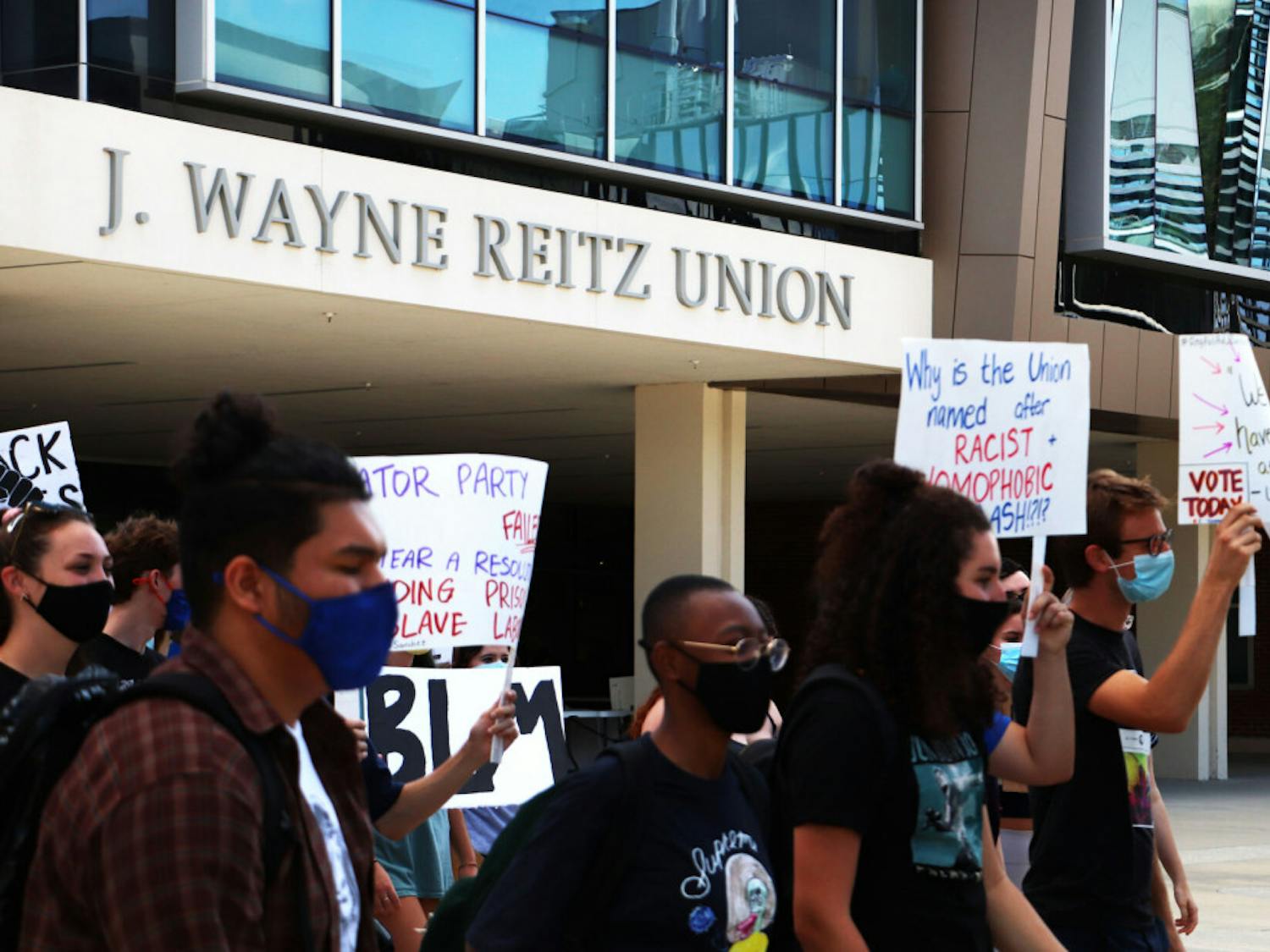 Protesters are seen walking from the Reitz Student Union towards Tigert Hall on Tuesday, Oct. 6, 2020. 