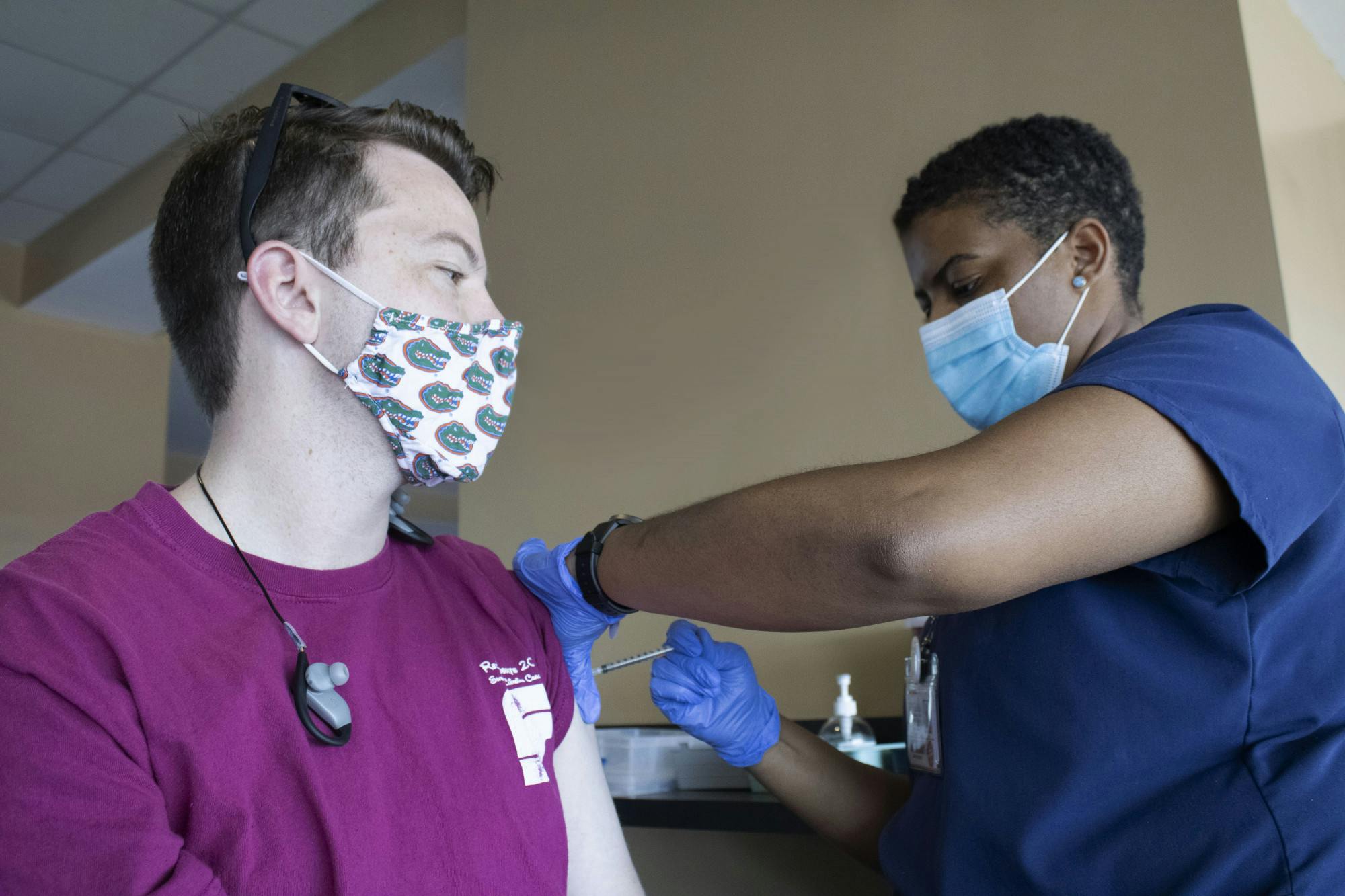 Frank Daldine, 19, a UF mechanical engineering sophomore (left) receives his first dose of the Pfizer-BioNTech COVID-19 vaccine on Monday, April 5, 2021. Monday was the first day COVID-19 vaccines were made widely available to UF students. 