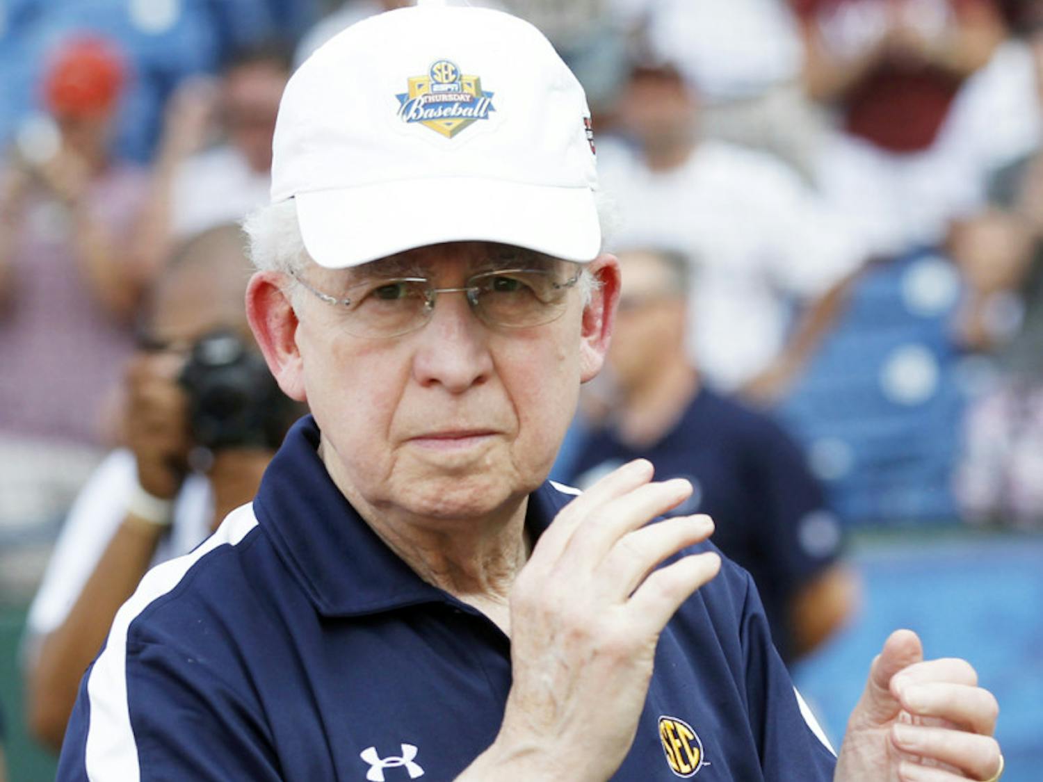 Southeastern Conference commissioner Mike Slive applauds at the SEC Tournament on May 27. Slive contributed to the development of college football’s new four-team playoff format.