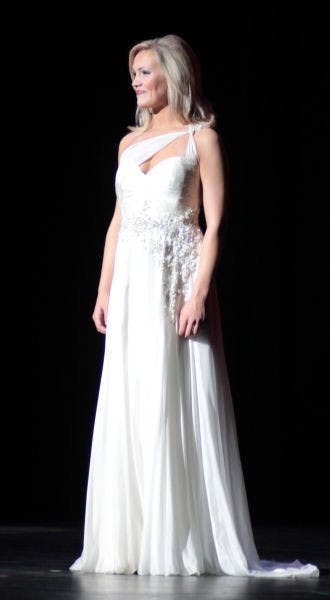 &nbsp;
Telecommunication sophomore Elizabeth Fechtel of Alpha Delta Pi displays her choice of evening wear during Miss UF 2014 at the Curtis M. Phillips Center for the Performing Arts on Monday night.