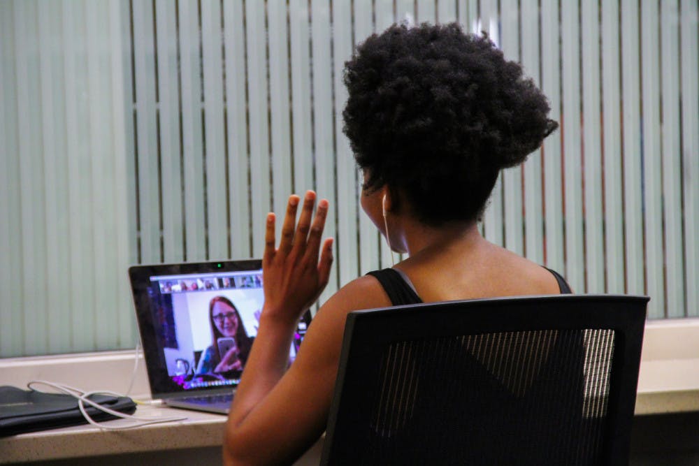 <p>Nomfumo Manaba, a 23-year-old UF journalism and political science junior, video calls into her class at Library West. </p>