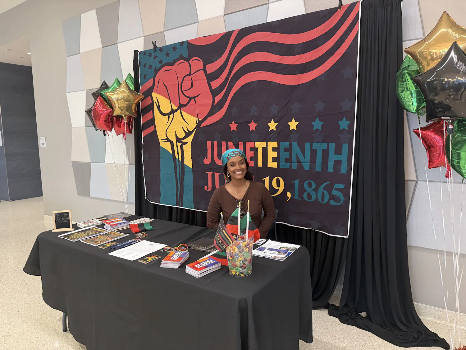 Shilah Carroll, an academic adviser at Santa Fe, hosts a table dedicated to the Black faculty at Santa Fe college. She had Juneteenth themed merchandise and information about other Juneteenth events in the community.