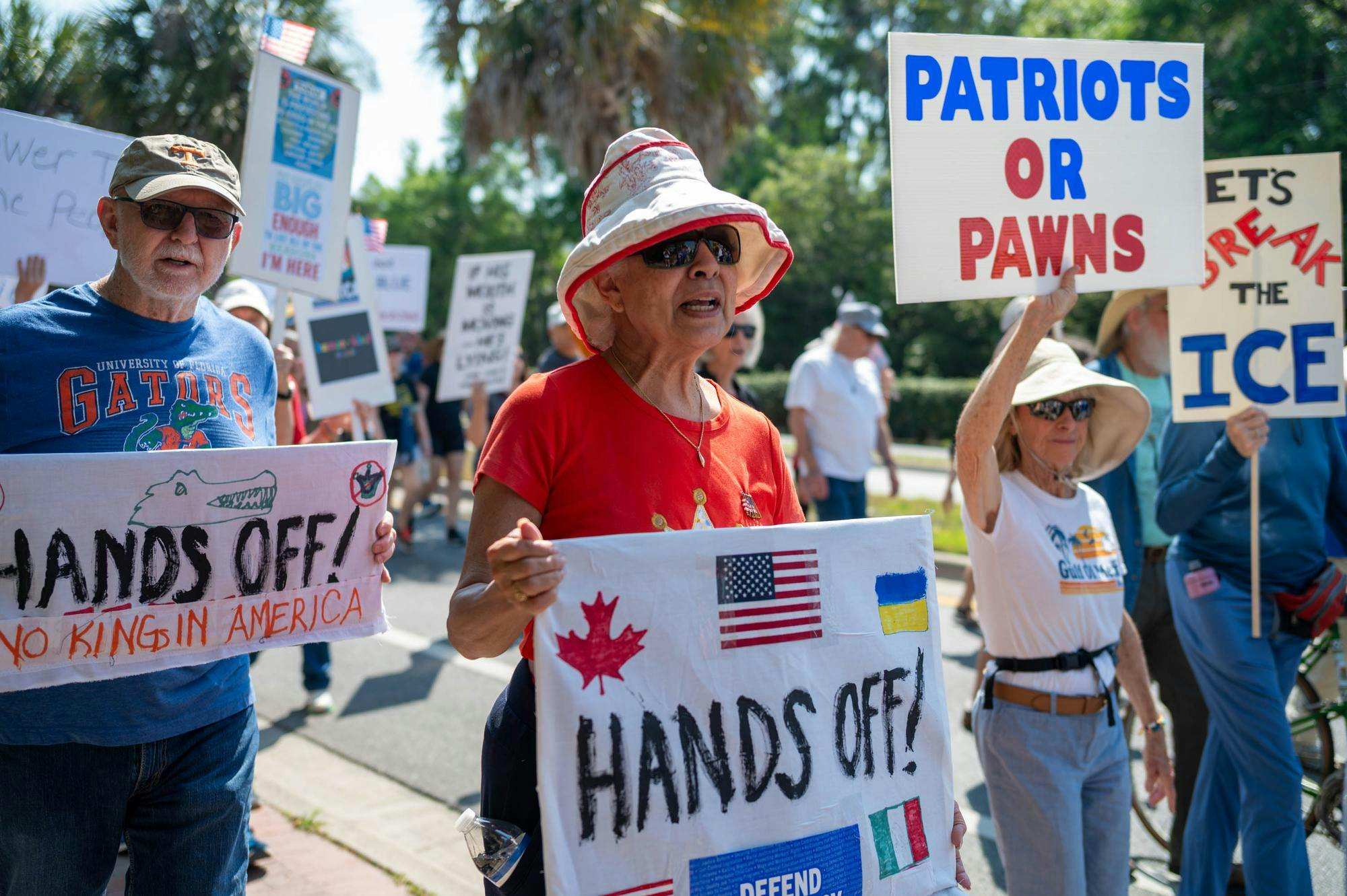 Protestors march down Depot Avenue, Saturday, March 28, 2026, in Gainesville, Fla.