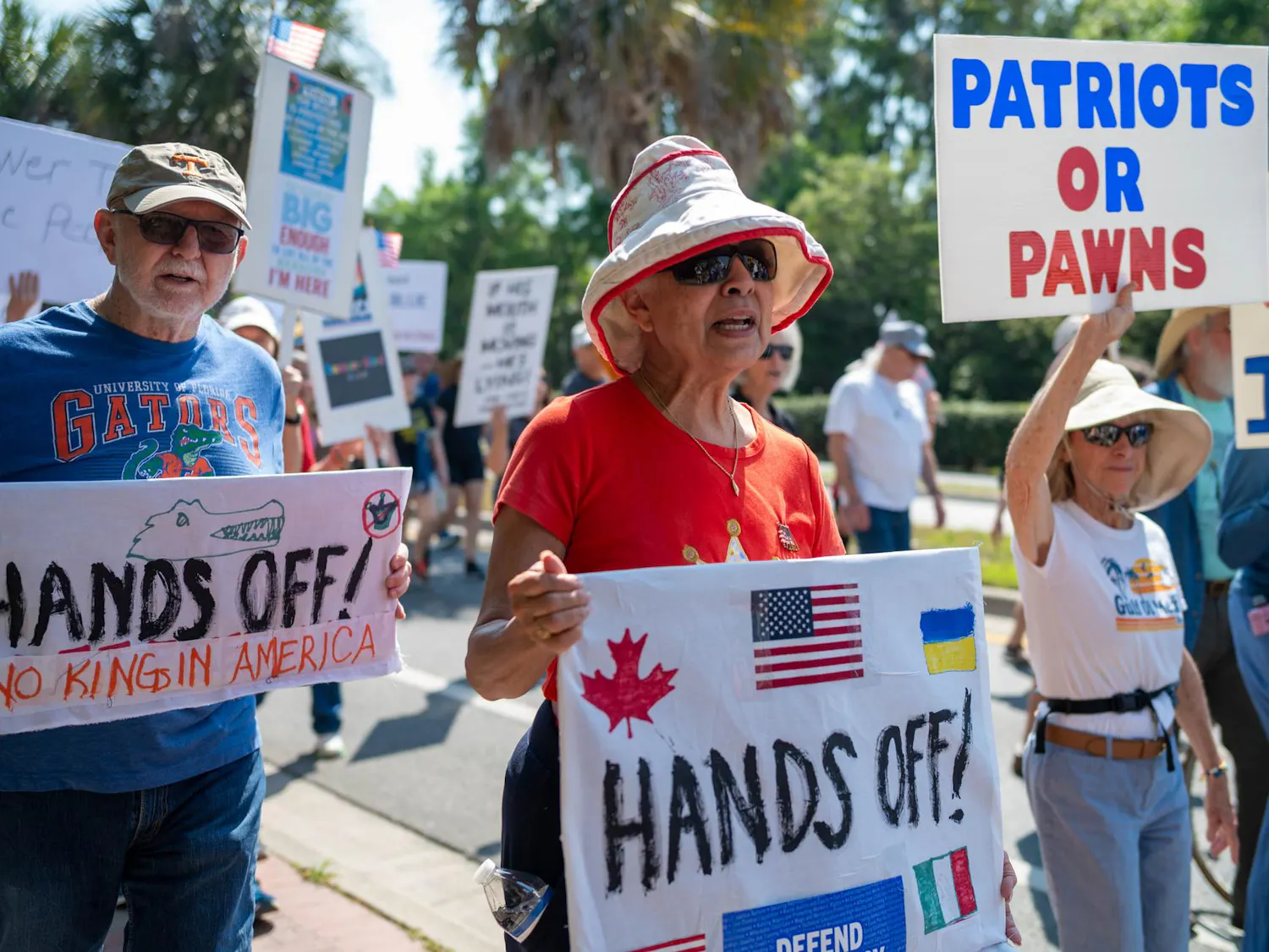 Protestors march down Depot Avenue, Saturday, March 28, 2026, in Gainesville, Fla.