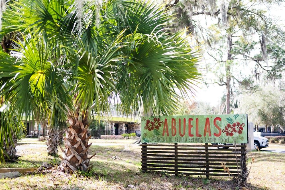 A sign for La Cocina de Abuela stands outside the restaurant in Gainesville, Fla., on Thursday, Feb. 13, 2025.