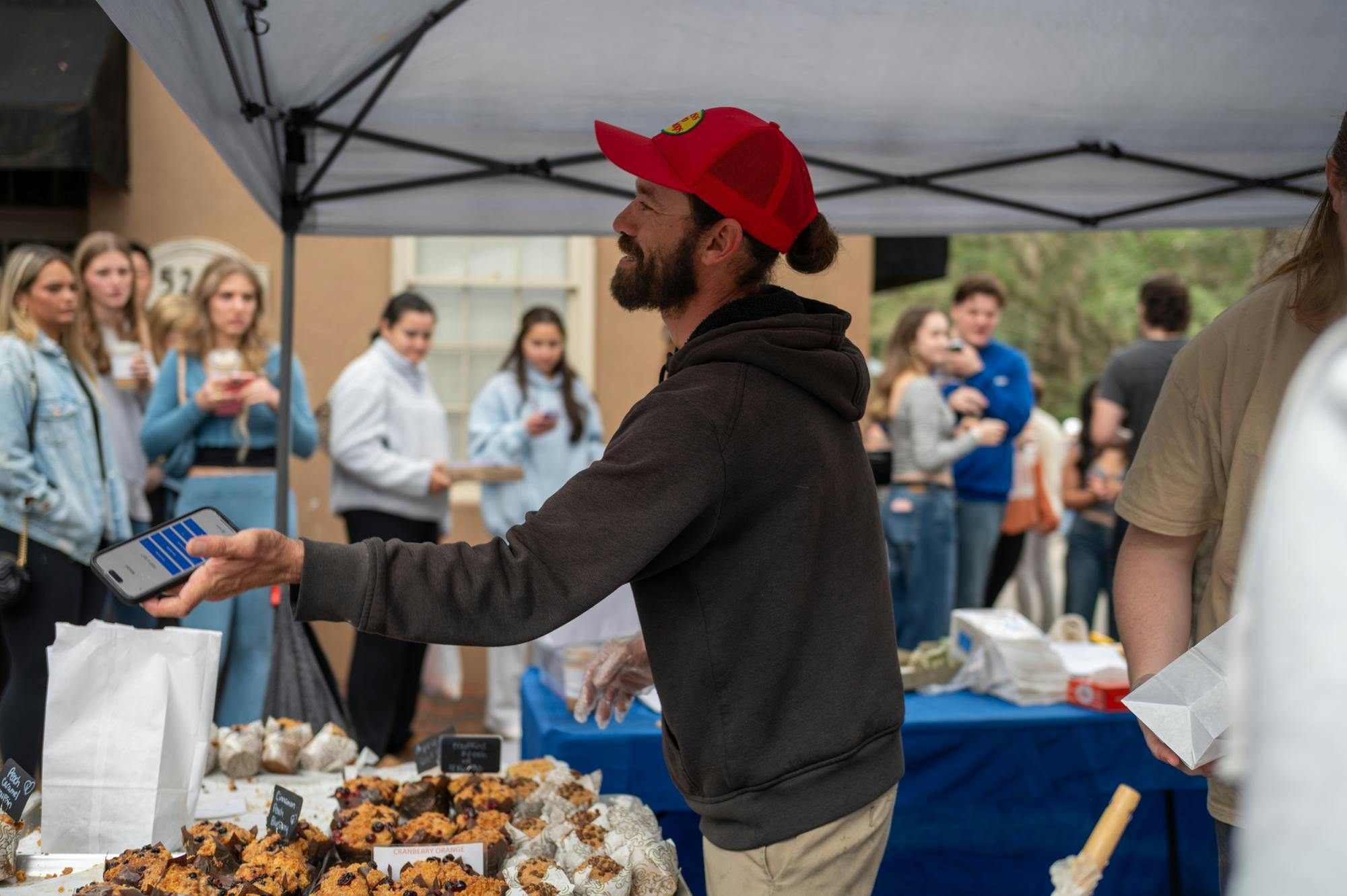 The Gourmet Muffin, a bakery based in Stuart, Fla., is one of the most popular vendors at Haile Plantation Farmers Market. A line wraps around their tent in Gainesville, Saturday, Jan. 24, 2026.