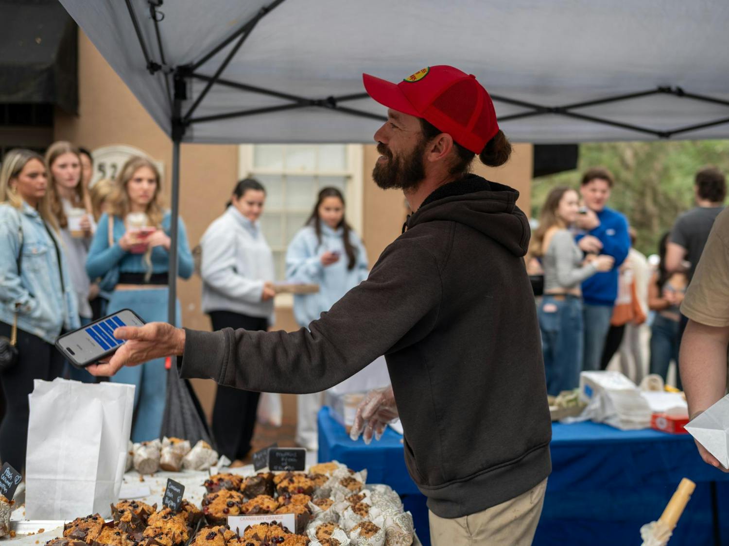 The Gourmet Muffin, a bakery based in Stuart, Fla., is one of the most popular vendors at Haile Plantation Farmers Market. A line wraps around their tent in Gainesville, Saturday, Jan. 24, 2026.