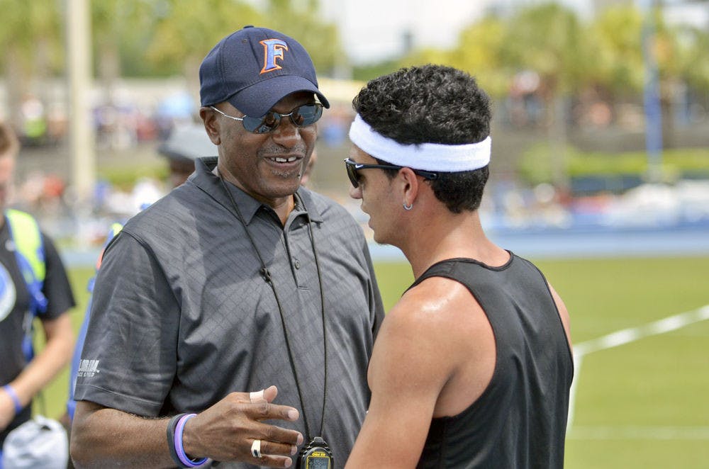 UF track and field coach Mike Holloway talks with mid-distance runner Andres Arroyo on the final day of the 2015 Florida Relays on Saturday at the Percy Beard Track.