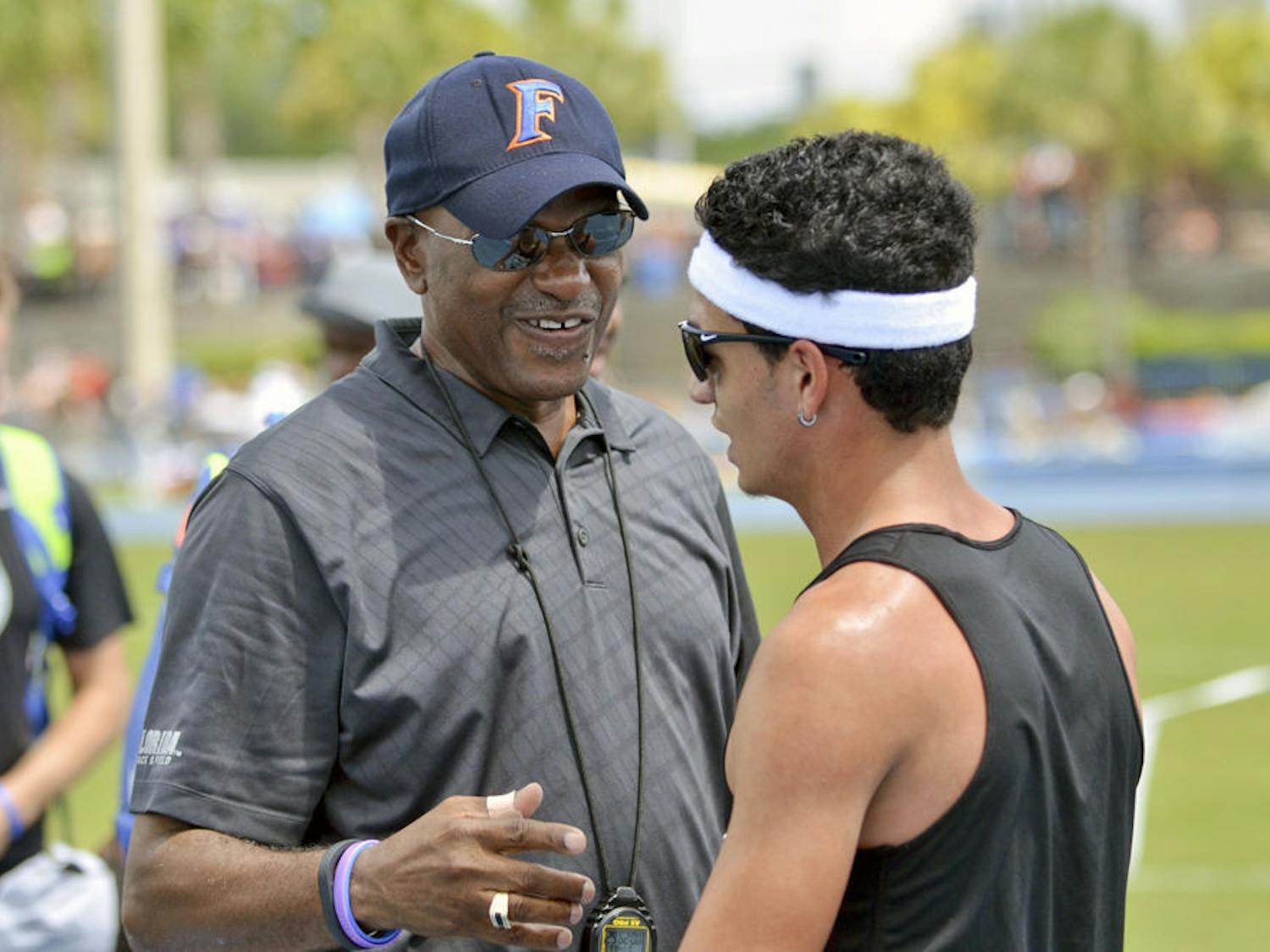 UF track and field coach Mike Holloway talks with mid-distance runner Andres Arroyo on the final day of the 2015 Florida Relays on Saturday at the Percy Beard Track.