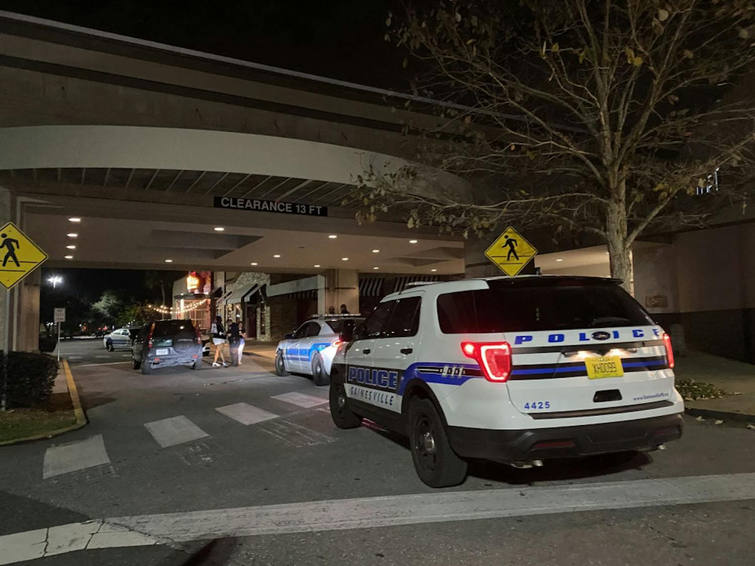 Law enforcement officers interview witnesses in front of Oaks Mall Thursday night after reports of a robbery in front of Pearle Vision, an eye care store located inside the mall.&nbsp;