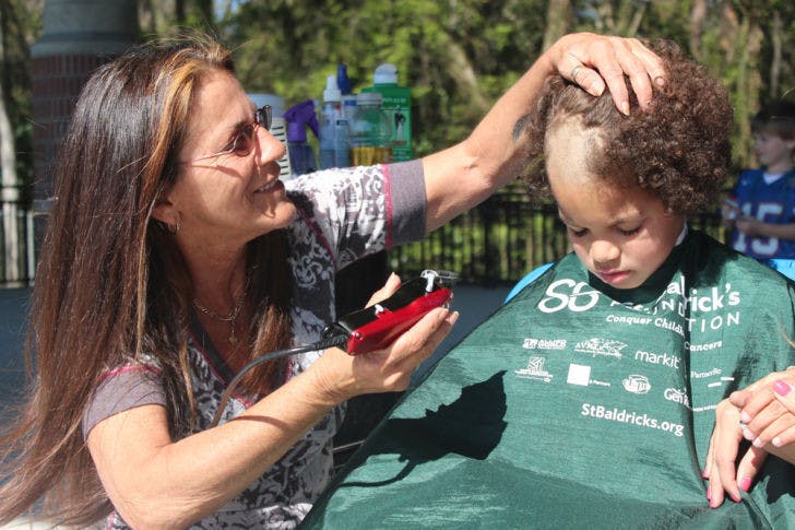 Marguerite Gaisser shaves Dwayne Lewis’ head Friday afternoon on Flavet Field as part of the Freshman Leadership Council’s annual St. Baldrick’s event benefiting cancer research. The 7-year-old, who is blind due to retinoblastoma, got his head shaved to celebrate being cancer-free for five years.