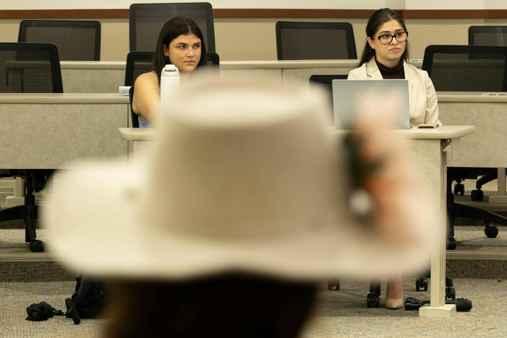 Kayla Arora, representative from Hope Party, faces Berkley Morris (left), a senator for Vision Party, and Monique Alfonso (right), a representative from Vision Party, during a hearing for the election violations complaint filed against Vision Party at the University of Florida Levin College of Law, Monday, Oct. 5, 2026, in Gainesville, Fla.