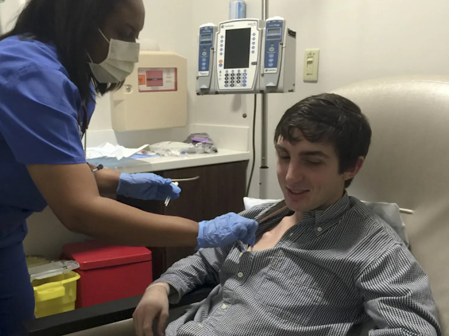 Daniel Ellis, a 22-year-old UF alumnus who graduated with a degree in business administration, waits as a nurse sterilizes an IV port during his fifth round of chemotherapy. In early December, Ellis was diagnosed with Hodgkin’s lymphoma.
