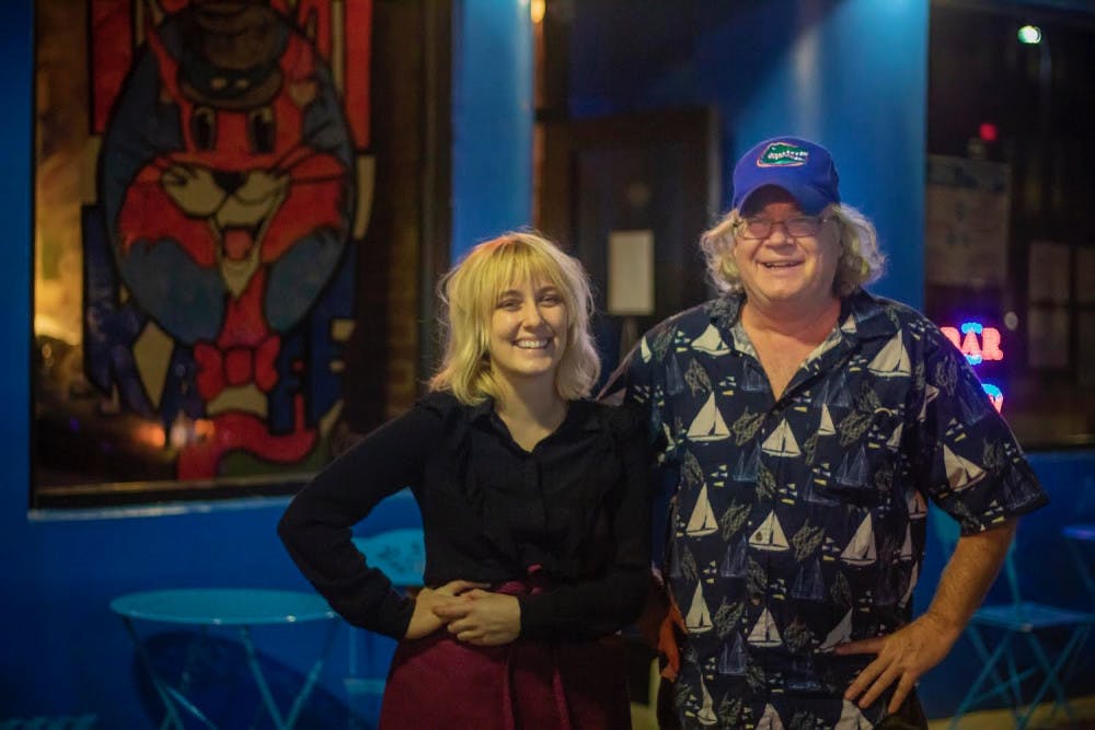 <p>Owner Tom Fox and manager Emma Grimm stand outside Tom Kat Kafe, a new vegetarian cafe that opened during the COVID-19 pandemic. </p>
