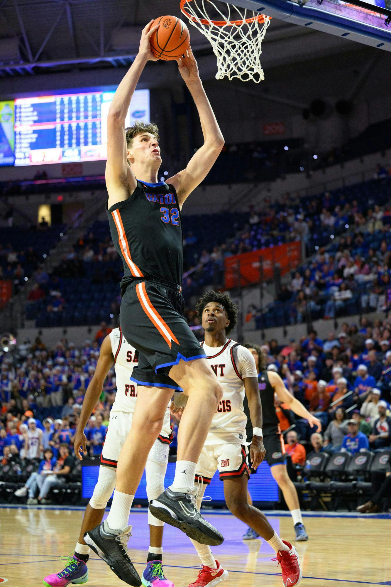 Florida center Olivier Rioux (32) dunks during the second half of an NCAA college basketball game against Saint Francis, Wednesday, Dec. 17, 2025, in Gainesville, Fla.