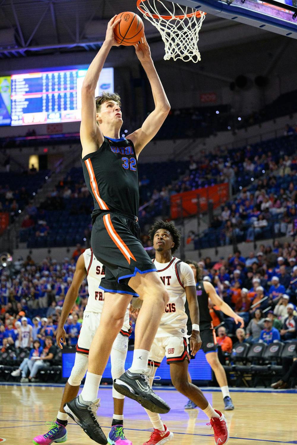 Florida center Olivier Rioux (32) dunks during the second half of an NCAA college basketball game against Saint Francis, Wednesday, Dec. 17, 2025, in Gainesville, Fla.