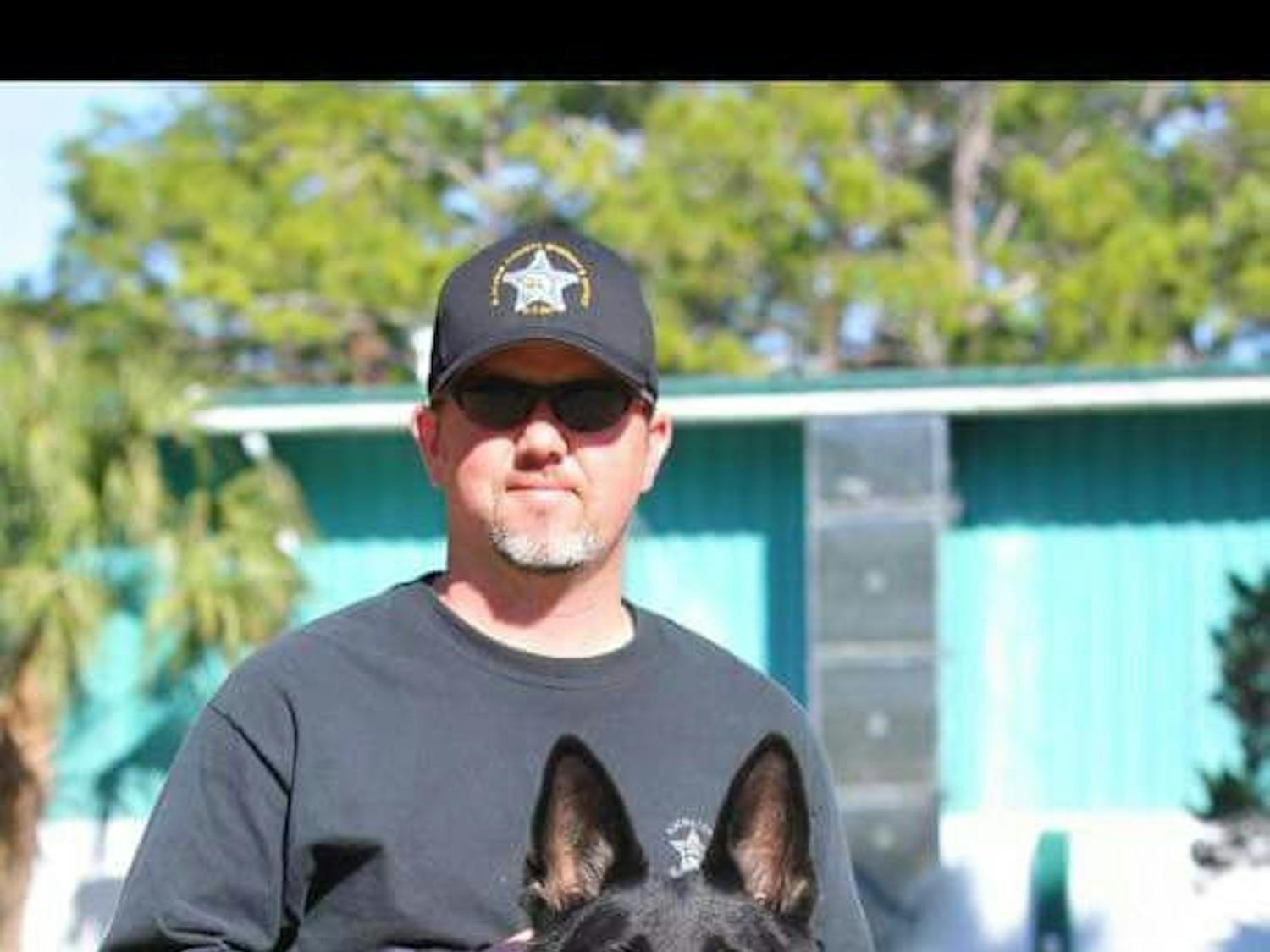 ACSO Deputy Clint Ferguson pictured in Jauary 2016 with his former police dog Vader.