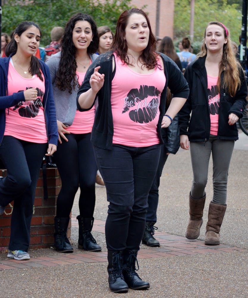 Kelsey Roessler, a 21-year-old UF accounting junior, performs Wednesday on Turlington Plaza with a capella group the Sedoctaves. 