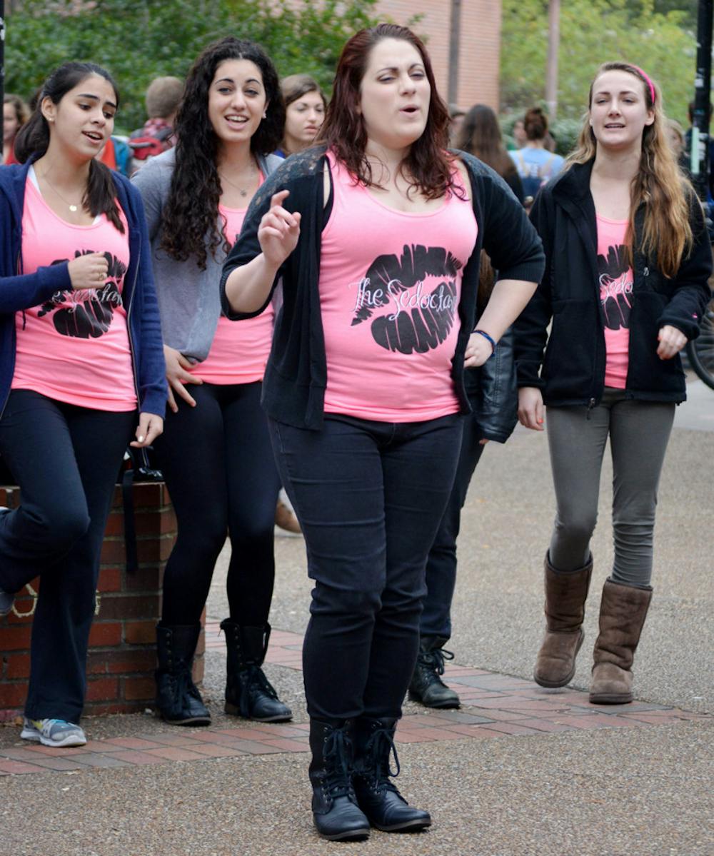 <p class="p1">Kelsey Roessler, a 21-year-old UF accounting junior, performs Wednesday on Turlington Plaza with a capella group the Sedoctaves. </p>