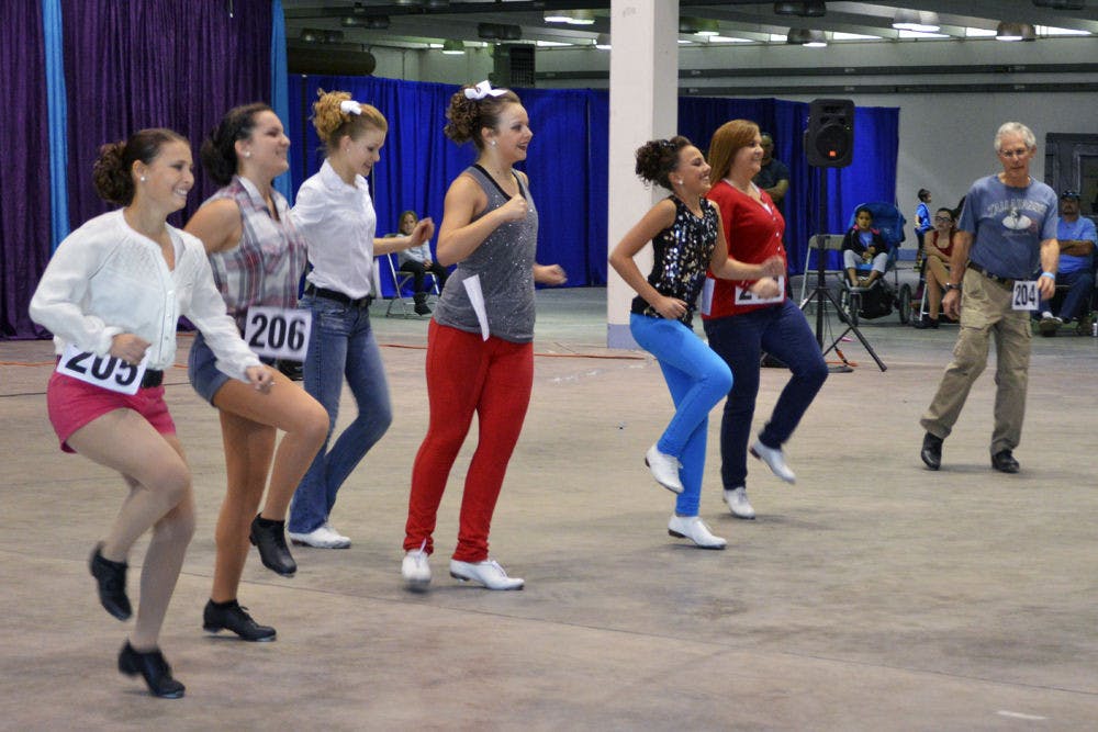 A group of clog dancers performs at Gainesville’s first clogging festival, which was on the Alachua County Fairgrounds on Saturday. Eight teams competed in the Florida Clogging Festival and will advance to two national competitions.