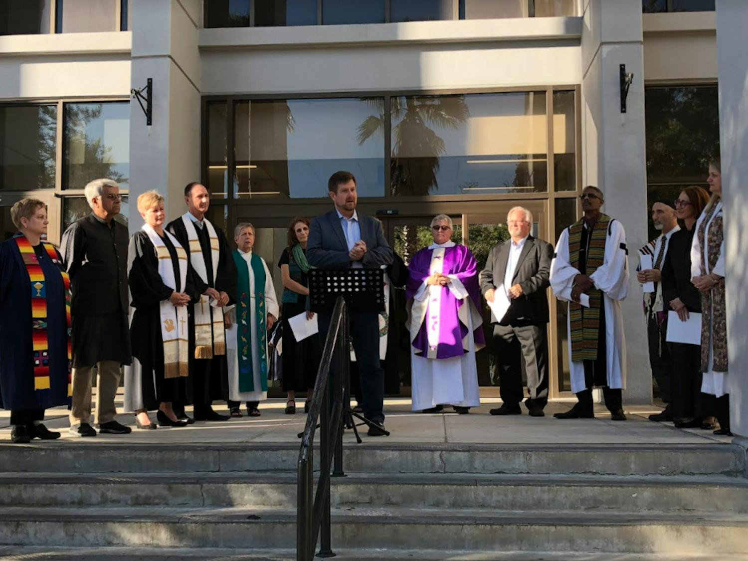 Mayor Lauren Poe calls on a crowd of 30 people to denounce hate speech and anti-semitism Tuesday afternoon outside of City Hall. When one person is harmed, it takes a toll on everyone, he said. 