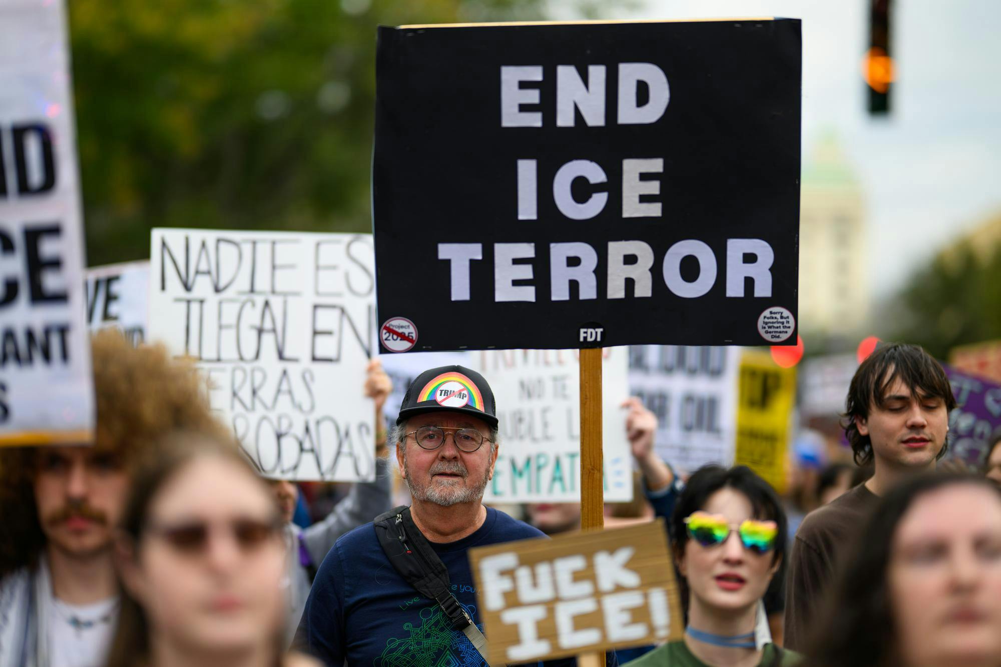 A demonstrator holds a sign during an ICE protest organized by YDSA, Friday, Jan. 30, 2026, along University Avenue in Gainesville, Fla.
