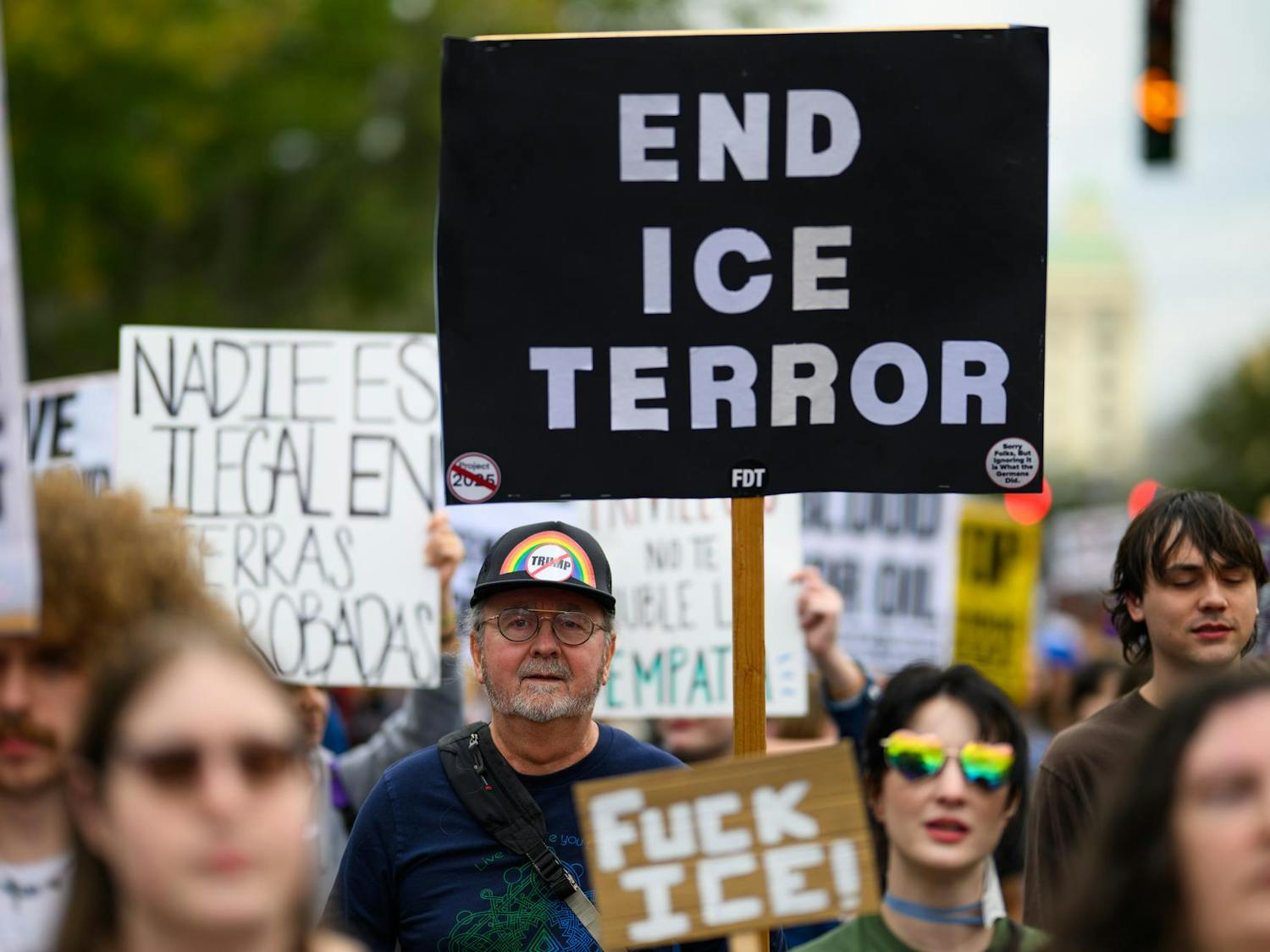 A demonstrator holds a sign during an ICE protest organized by YDSA, Friday, Jan. 30, 2026, along University Avenue in Gainesville, Fla.