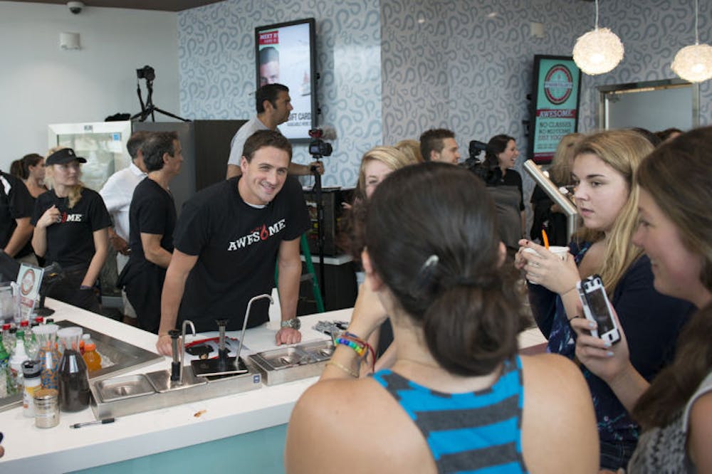 <p>Ryan Lochte helps serve frozen yogurt to visitors at Yogurtology, 3730 Southwest Archer Road, on Saturday. The Olympic medalist partnered with the franchise to help raise money for charities he supports such as the Mac Crutchfield Foundation and Parent Project Muscular Dystrophy.</p>