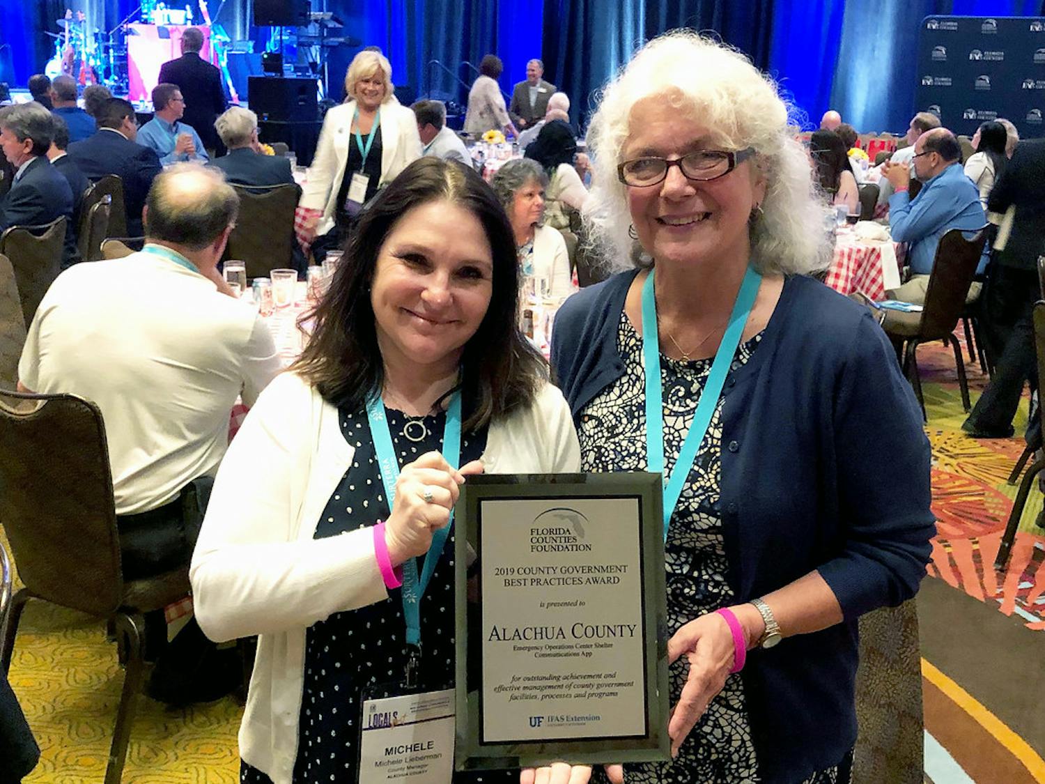 County Commissioner Marihelen Wheeler (right) and County Manager Michele Lieberman (left) accept the award from&nbsp;the Florida Counties Foundation at the Florida Association of Counties. Alachua was one of seven counties recognized at the ceremony