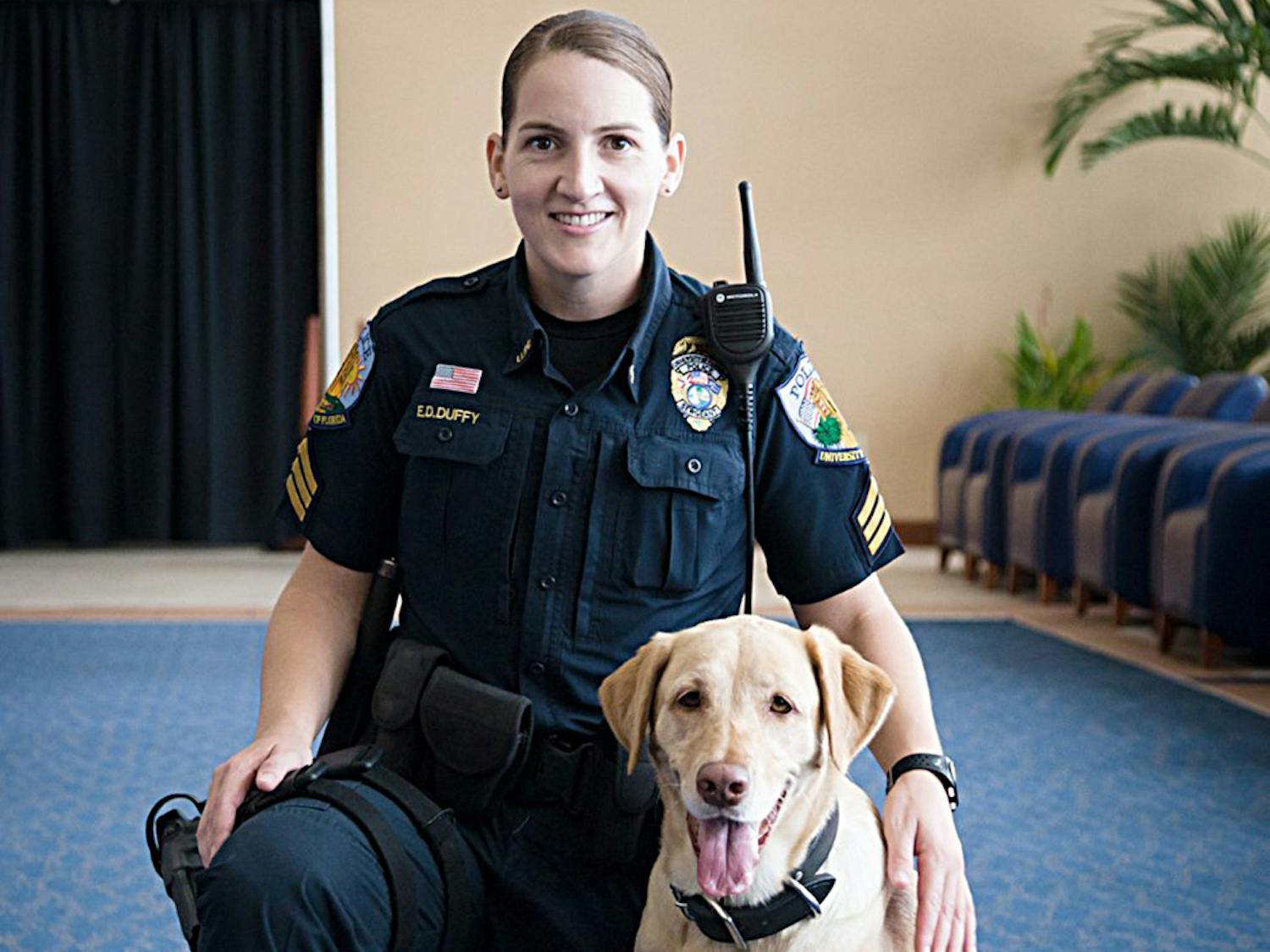 Sergeant Ellen Duffy poses with her 4-year-old lab, Amber, one of the dogs expected to receive a free exam during the American College of Veterinary Ophthalmologists’ National Service Dog Eye Exam event at the UF Small Animal Hospital.