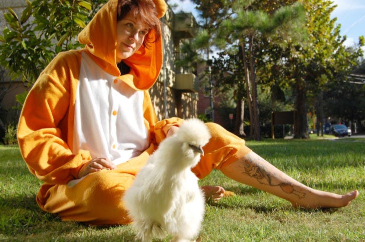 Mikal van Oene, 22, sits with her chicken, Doctor Peeps, Ph.D., outside her home. Van Oene performed surgery on her companion after she was attacked by a hawk.