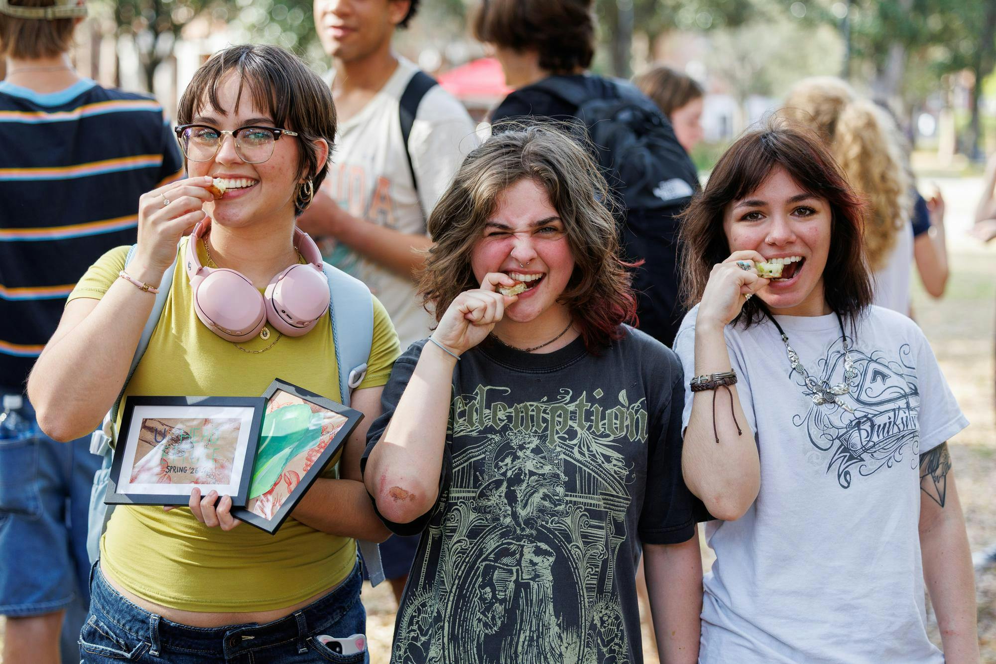 Junior Jennifer Rodriguez Perez, Sophomore Zoe Englander, and Junior Charley Fike celebrate their top 3 finishes during the UF Lettuce Club lettuce eating competition on Thursday, Feb. 19, 2026, in Gainesville, Fla.
