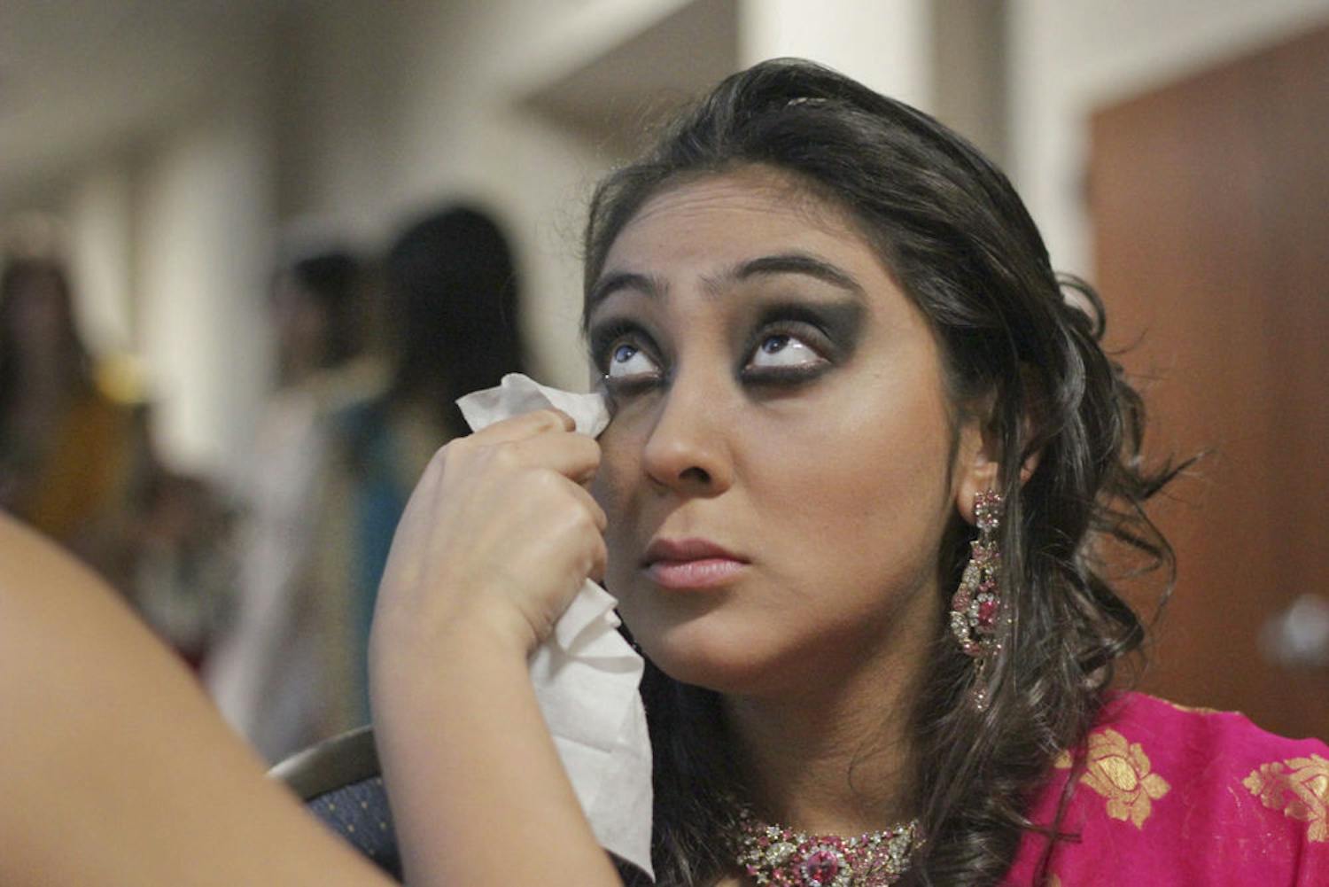Valentina Lopez-Diaz gets made-up before modeling a Shama Boutique saree in Asian Kaleidoscope Month's "Immortal" Fashion Show. "I've always wanted to model, but I'm petite," the 19-year-old UF marketing sophomore said. She had modeled commercially before and decided to try out for the show after hearing it was open to models of all races and sizes.