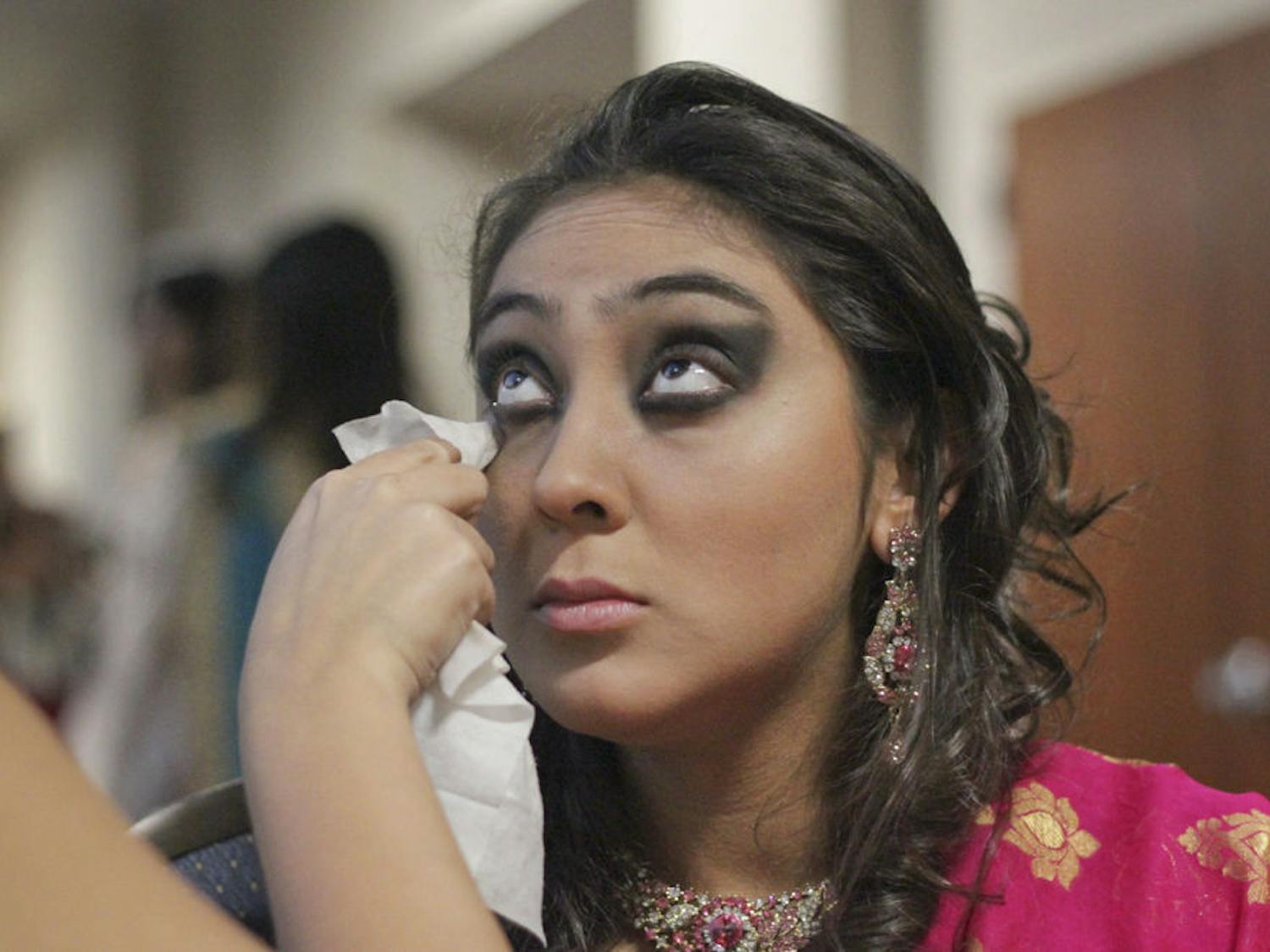 Valentina Lopez-Diaz gets made-up before modeling a Shama Boutique saree in Asian Kaleidoscope Month's "Immortal" Fashion Show. "I've always wanted to model, but I'm petite," the 19-year-old UF marketing sophomore said. She had modeled commercially before and decided to try out for the show after hearing it was open to models of all races and sizes.