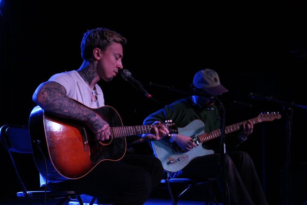 Musicians Noah Gundersen (left) and Harrison Whitford (right) collaborate during an acoustic performance on Sunday.