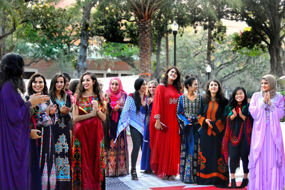Models gather at the end of a makeshift runway on the Plaza of the Americas following a fashion show hosted by UF Students for Justice in Palestine. The show was the organization’s first event of the Fall semester and showcased traditional Arab clothing.
