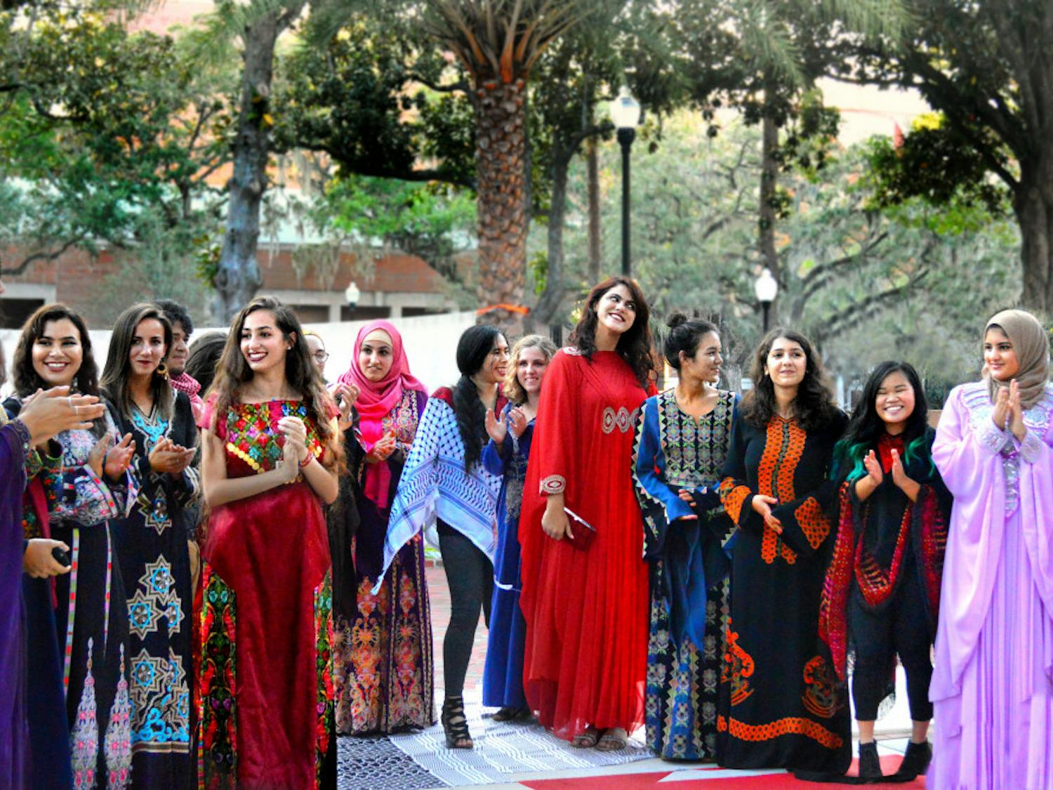 Models gather at the end of a makeshift runway on the Plaza of the Americas following a fashion show hosted by UF Students for Justice in Palestine. The show was the organization’s first event of the Fall semester and showcased traditional Arab clothing.
