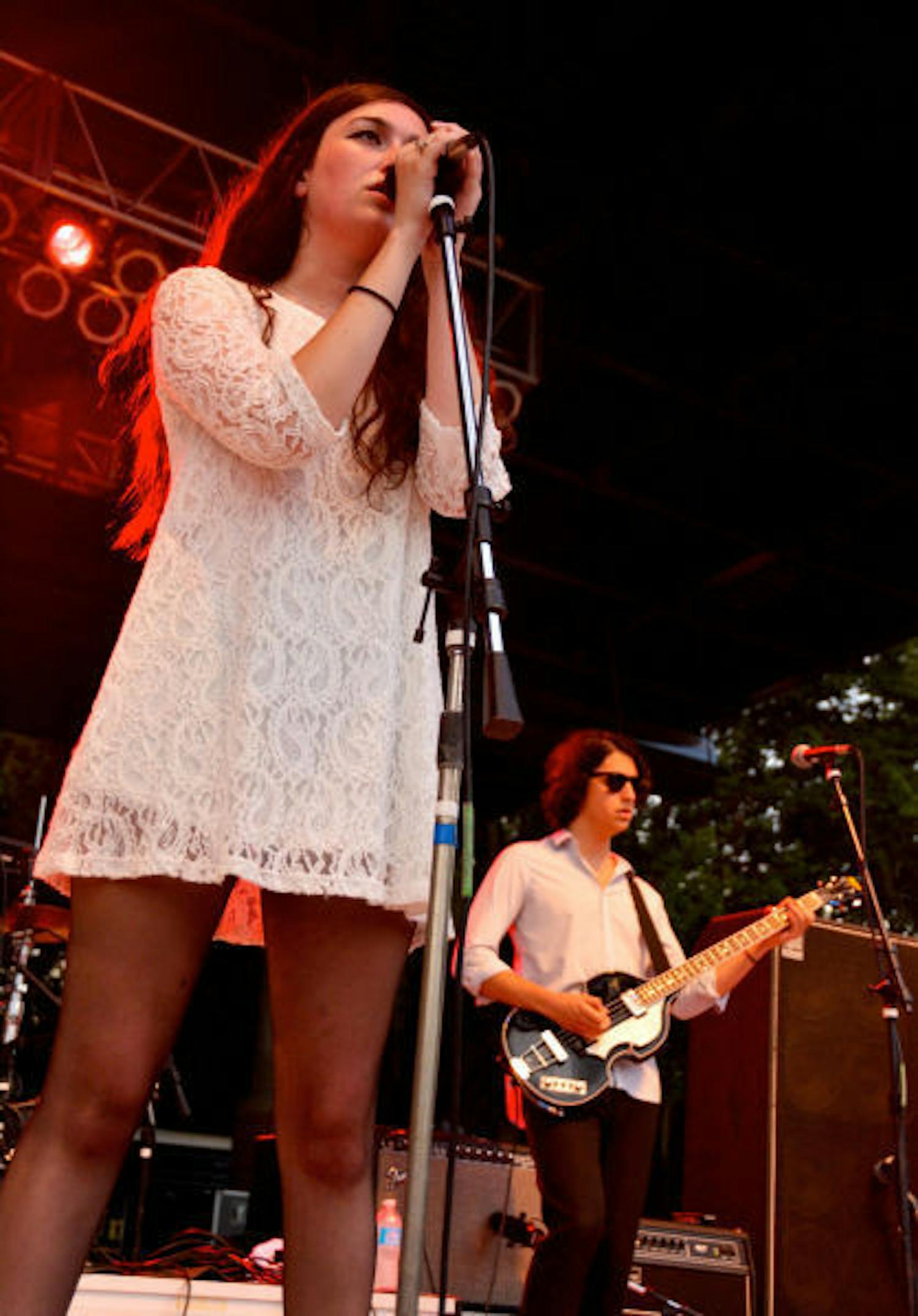 Madeline Follin (left), of Cults, sings on Friday during Swampfest 2013. Cults opened, along with the band AHMIR,&nbsp;for Matt and Kim, whose performance was canceled due to thunderstorms.