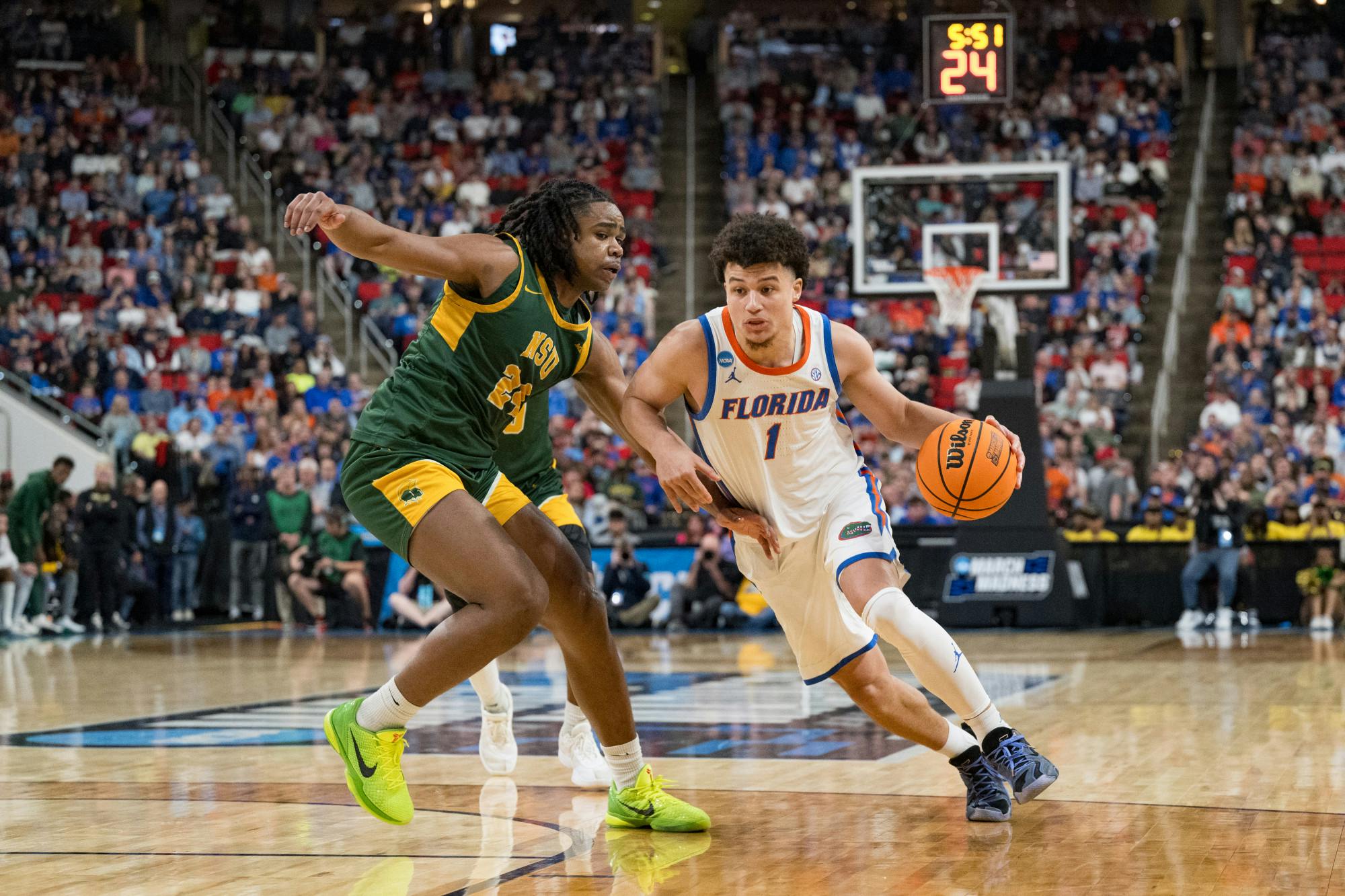 Florida Gators guard Walter Clayton Jr. (1) drives with the ball during a basketball game against Norfolk State in the first round of the NCAA Tournament on Friday, March 21, 2025, in Raleigh, N.C.