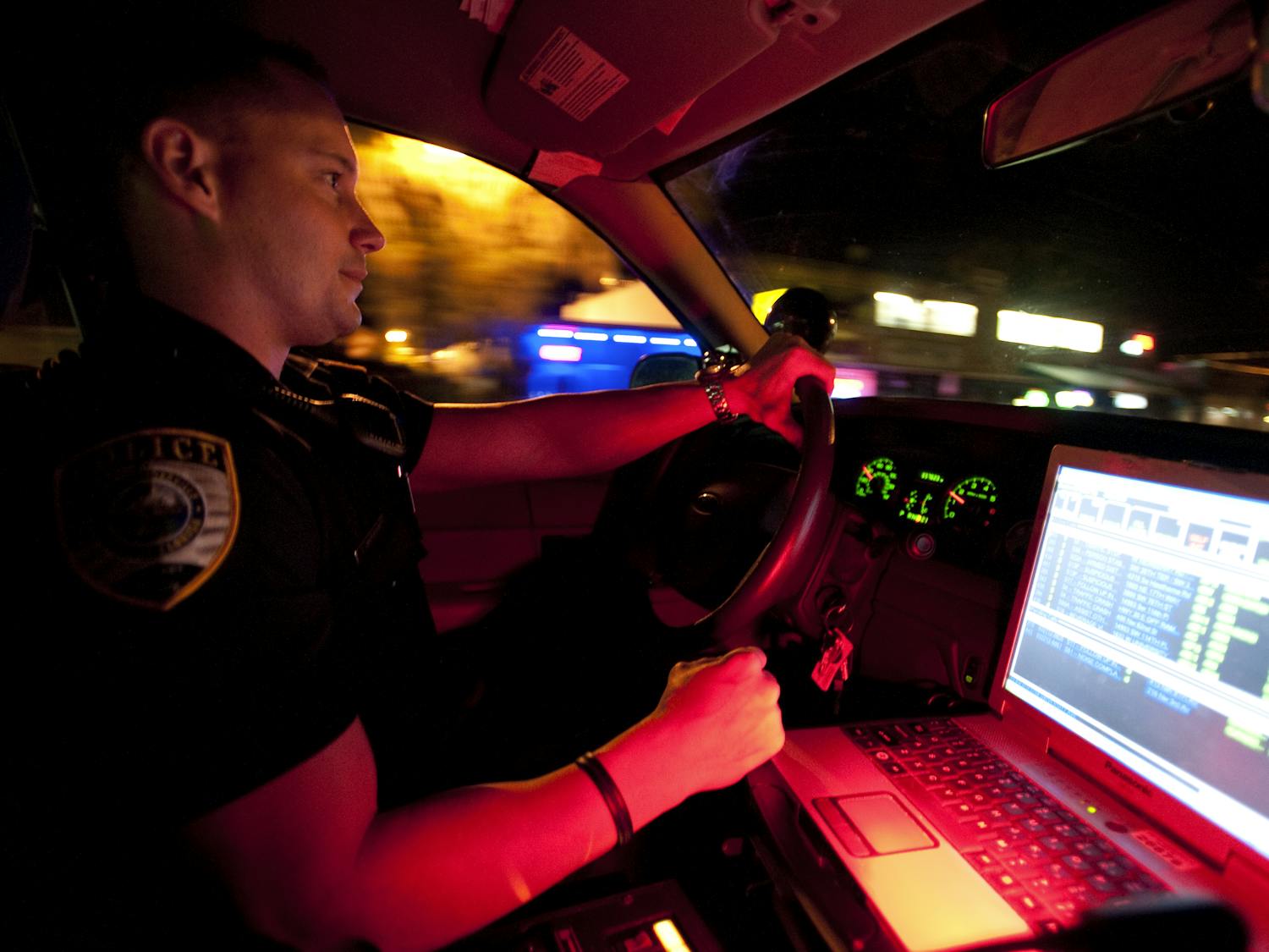 Gainesville Police officer Thomas Harrison drives his cruiser down University Avenue early Thursday morning.