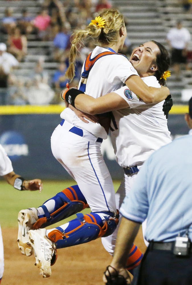 Florida pitcher Lauren Haeger, right, celebrates with catcher Aubree Munro at the end of the final game against Michigan in the NCAA softball Women's College World Series, Wednesday, June 3, 2015, in Oklahoma City. Florida won 4-1.